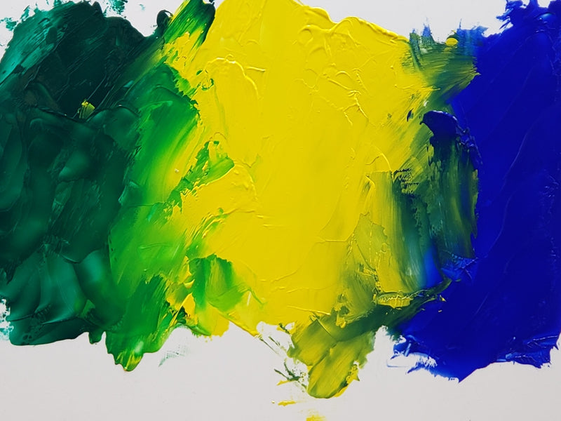 Basic Green at left mixing with Basic Yellow at center. Basic Blue, shown far right, makes a different green mixture with the Basic Yellow. 